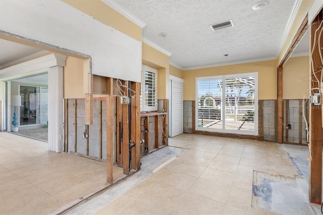 hall with crown molding and a textured ceiling