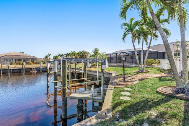 view of dock with a lawn, glass enclosure, and a water view