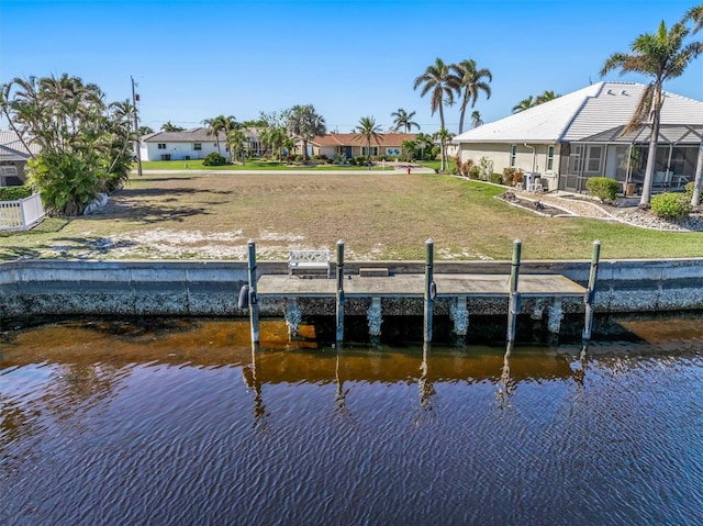 view of dock featuring a water view and a yard