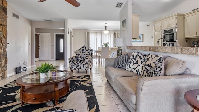 tiled living room featuring ceiling fan