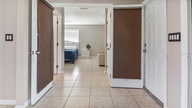 hallway featuring light tile patterned floors