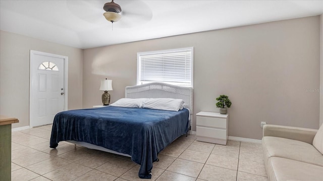 bedroom with ceiling fan and light tile patterned flooring