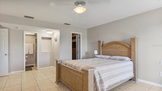 bedroom with connected bathroom, a spacious closet, a closet, and light tile patterned flooring