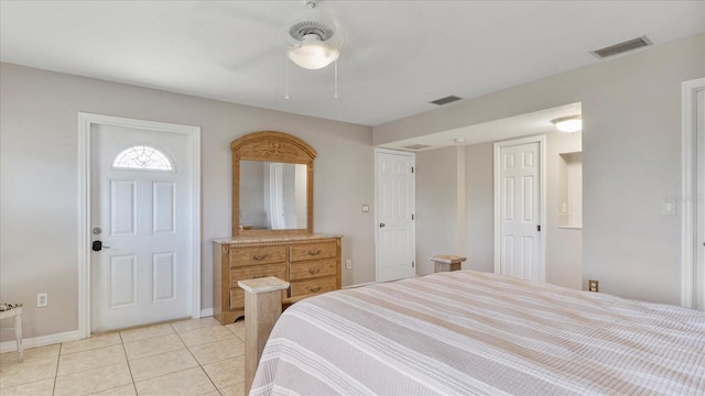 bedroom with ceiling fan and light tile patterned floors