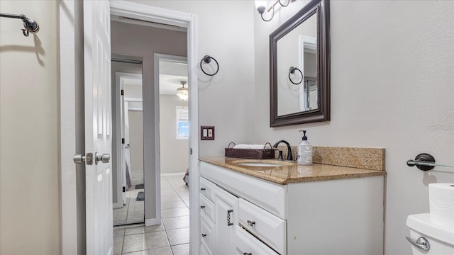 bathroom featuring tile patterned floors, vanity, and toilet