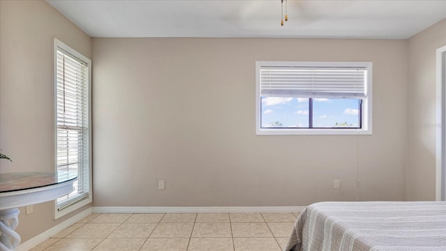 tiled bedroom featuring multiple windows