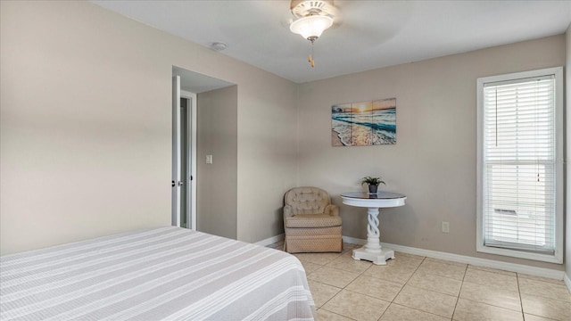 bedroom featuring light tile patterned floors and ceiling fan