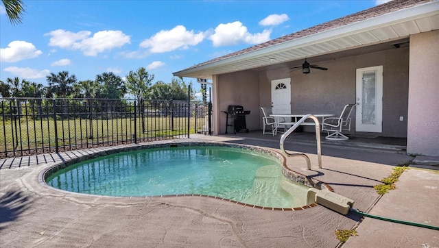 view of swimming pool with ceiling fan, area for grilling, and a patio