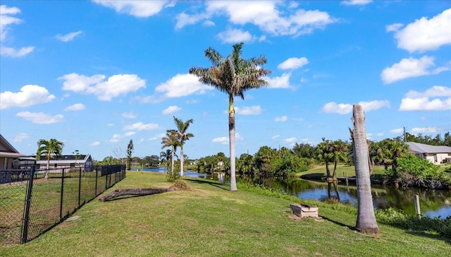 view of property's community with a yard and a water view