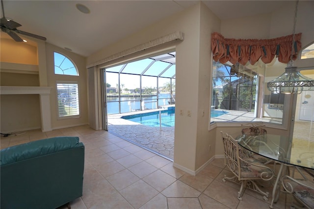 view of pool with ceiling fan and a water view