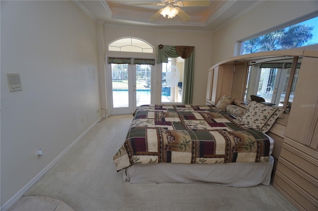 bedroom with french doors, access to outside, multiple windows, and ceiling fan