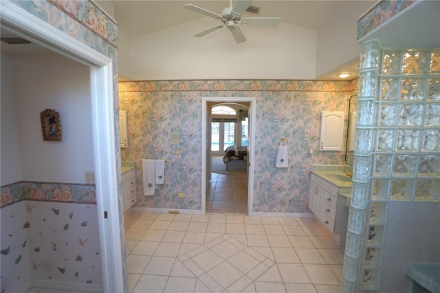 bathroom with tile patterned floors, vanity, vaulted ceiling, and ceiling fan