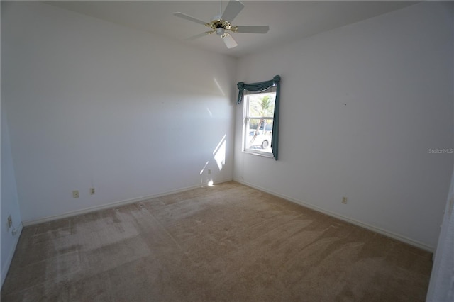 spare room featuring ceiling fan and carpet