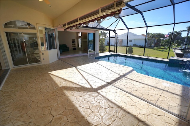 view of swimming pool featuring pool water feature, a lanai, and a patio area