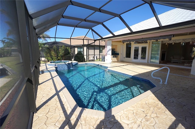 view of pool with glass enclosure, a patio area, an in ground hot tub, and french doors