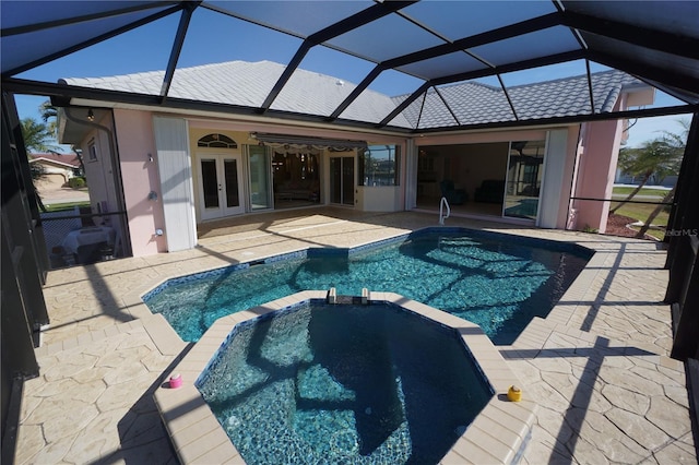 view of swimming pool featuring a lanai, a patio, and french doors