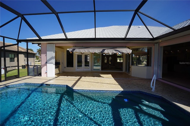 view of swimming pool featuring a lanai and a patio area