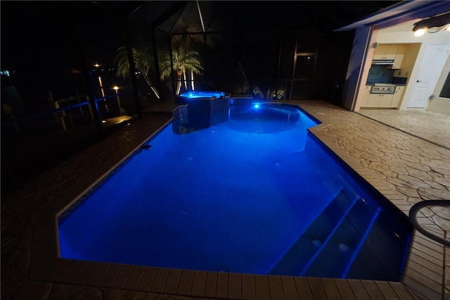 pool at twilight featuring a lanai, a patio area, and a pool with connected hot tub