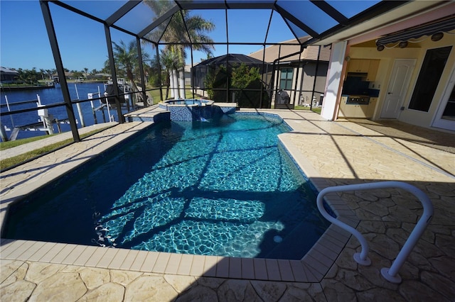 view of swimming pool featuring glass enclosure, a patio, an outdoor kitchen, a water view, and a pool with connected hot tub