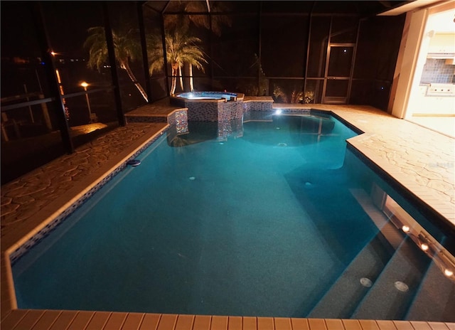 view of swimming pool with a patio area, a pool with connected hot tub, and glass enclosure