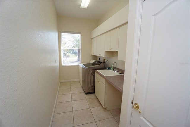 washroom with light tile patterned floors, cabinet space, a sink, electric dryer hookup, and baseboards