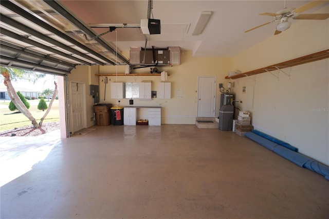 garage with water heater, ceiling fan, and a garage door opener