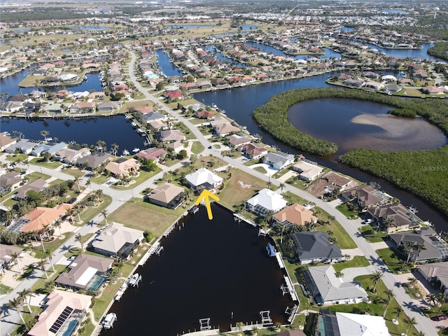 birds eye view of property featuring a water view and a residential view