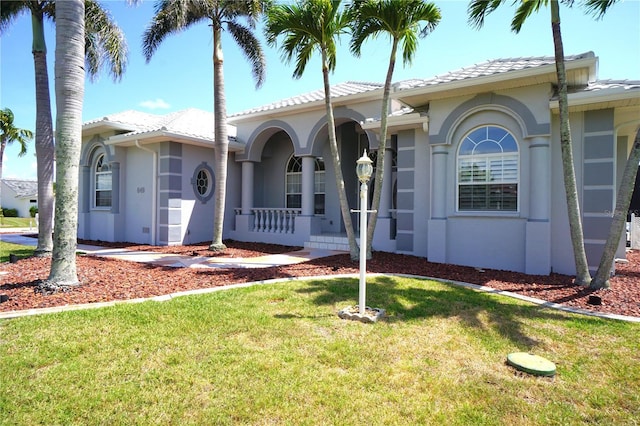 649 Maltese Dr, Punta Gorda, FL 33950 - view of front of house featuring a front yard, stucco siding, a tiled roof, and a porch