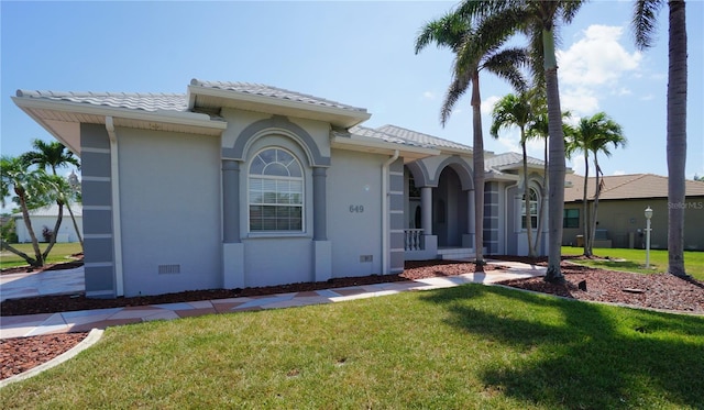 649 Maltese Dr, Punta Gorda, FL 33950 - view of front of home featuring a front lawn, a tiled roof, and stucco siding