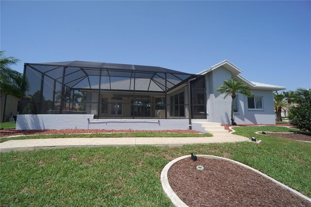 649 Maltese Dr, Punta Gorda, FL 33950 - back of house featuring a yard, stucco siding, and a lanai