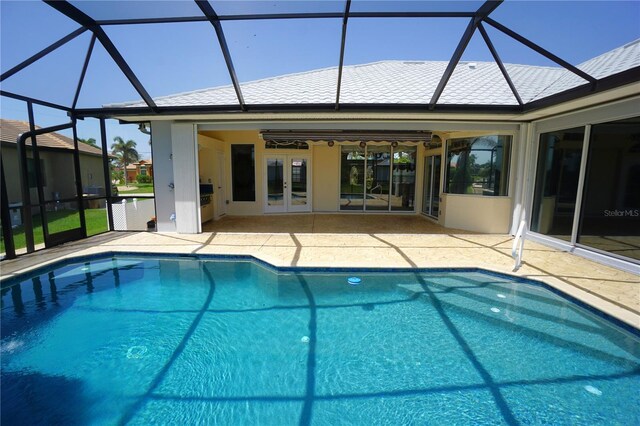 649 Maltese Dr, Punta Gorda, FL 33950 - outdoor pool featuring a patio area, glass enclosure, french doors, and ceiling fan