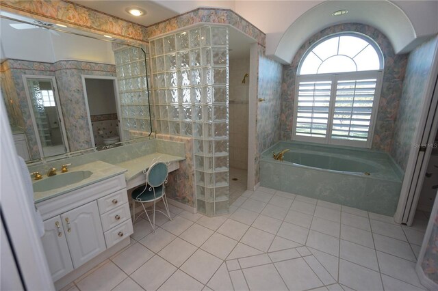 649 Maltese Dr, Punta Gorda, FL 33950 - full bathroom featuring a bath, tile patterned flooring, vanity, plenty of natural light, and wallpapered walls