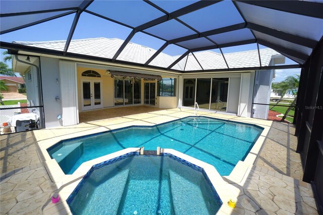 649 Maltese Dr, Punta Gorda, FL 33950 - view of swimming pool featuring french doors, a pool with connected hot tub, and a patio