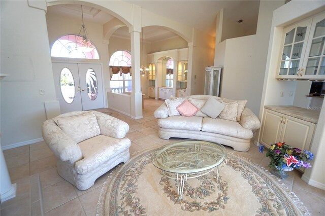 649 Maltese Dr, Punta Gorda, FL 33950 - living room featuring arched walkways, french doors, high vaulted ceiling, baseboards, and light tile patterned floors