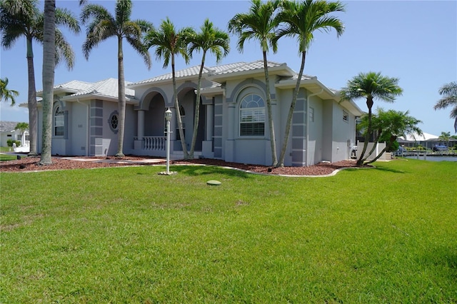 649 Maltese Dr, Punta Gorda, FL 33950 - mediterranean / spanish house with a front lawn, stucco siding, and a tile roof