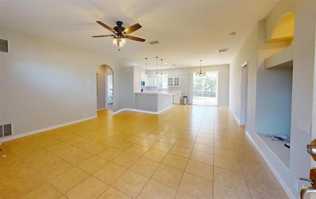 unfurnished living room with ceiling fan and light tile patterned floors