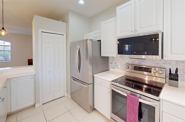 kitchen featuring decorative backsplash, stainless steel appliances, white cabinetry, and hanging light fixtures