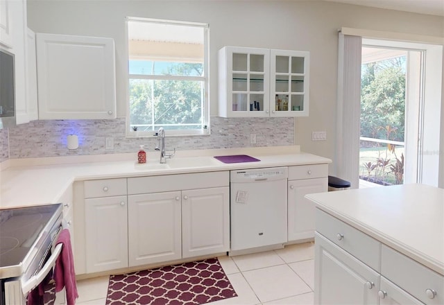 kitchen featuring backsplash, white cabinets, sink, and white dishwasher