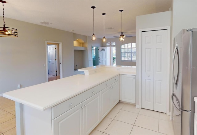 kitchen featuring stainless steel refrigerator, ceiling fan, white cabinets, and light tile patterned floors