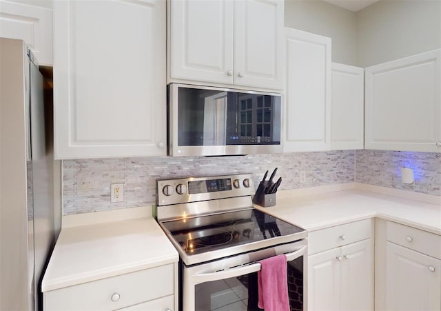 kitchen featuring white cabinets, backsplash, and stainless steel appliances