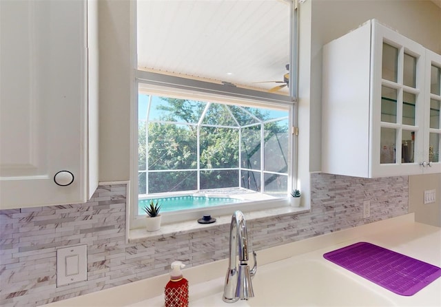 room details with tasteful backsplash and white cabinetry