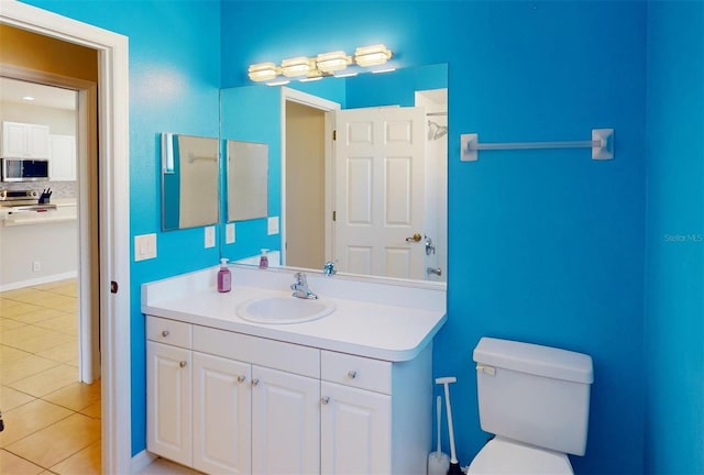 bathroom with tile patterned flooring, vanity, toilet, and backsplash