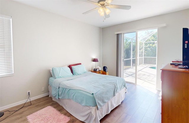 bedroom with ceiling fan, wood-type flooring, and access to outside