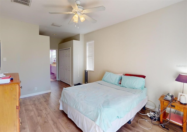 bedroom featuring a closet, light hardwood / wood-style flooring, and ceiling fan