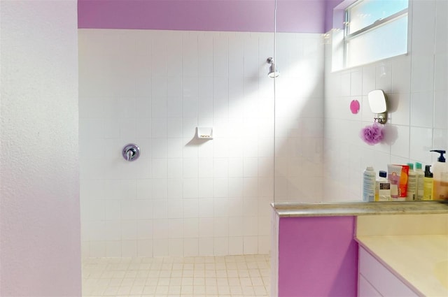 bathroom with vanity and tiled shower