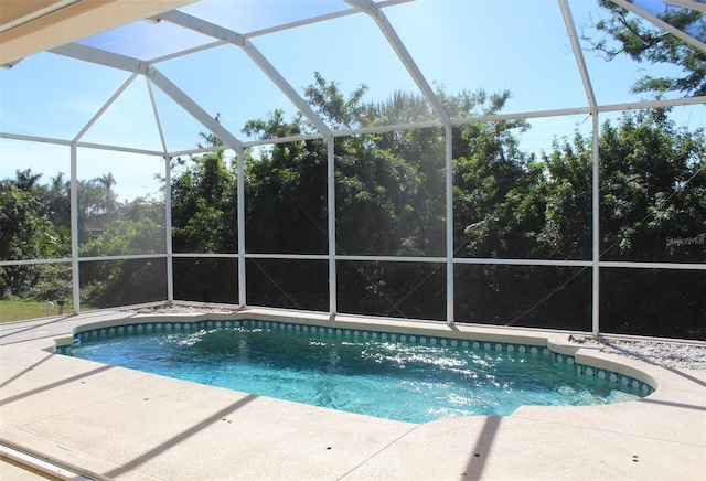 view of swimming pool featuring a lanai