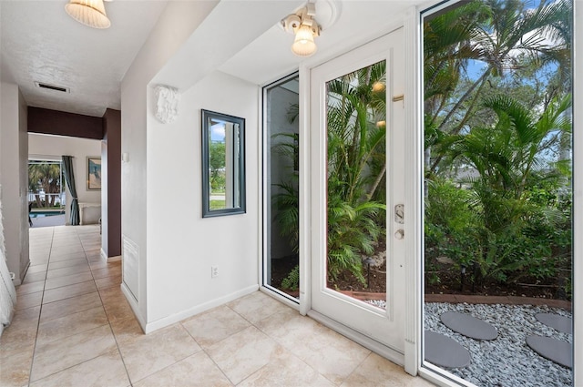 entryway with light tile patterned flooring