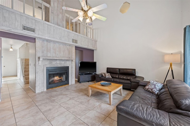 living room with tile patterned flooring, a high ceiling, and ceiling fan