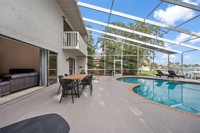 view of pool with a patio and glass enclosure