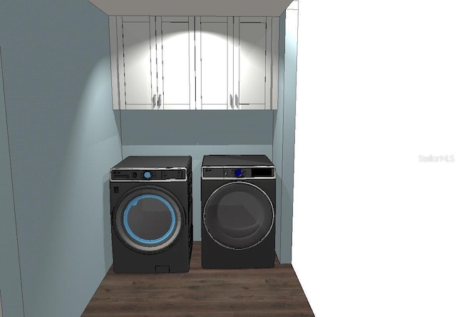 laundry area with cabinets, dark hardwood / wood-style floors, and washing machine and clothes dryer